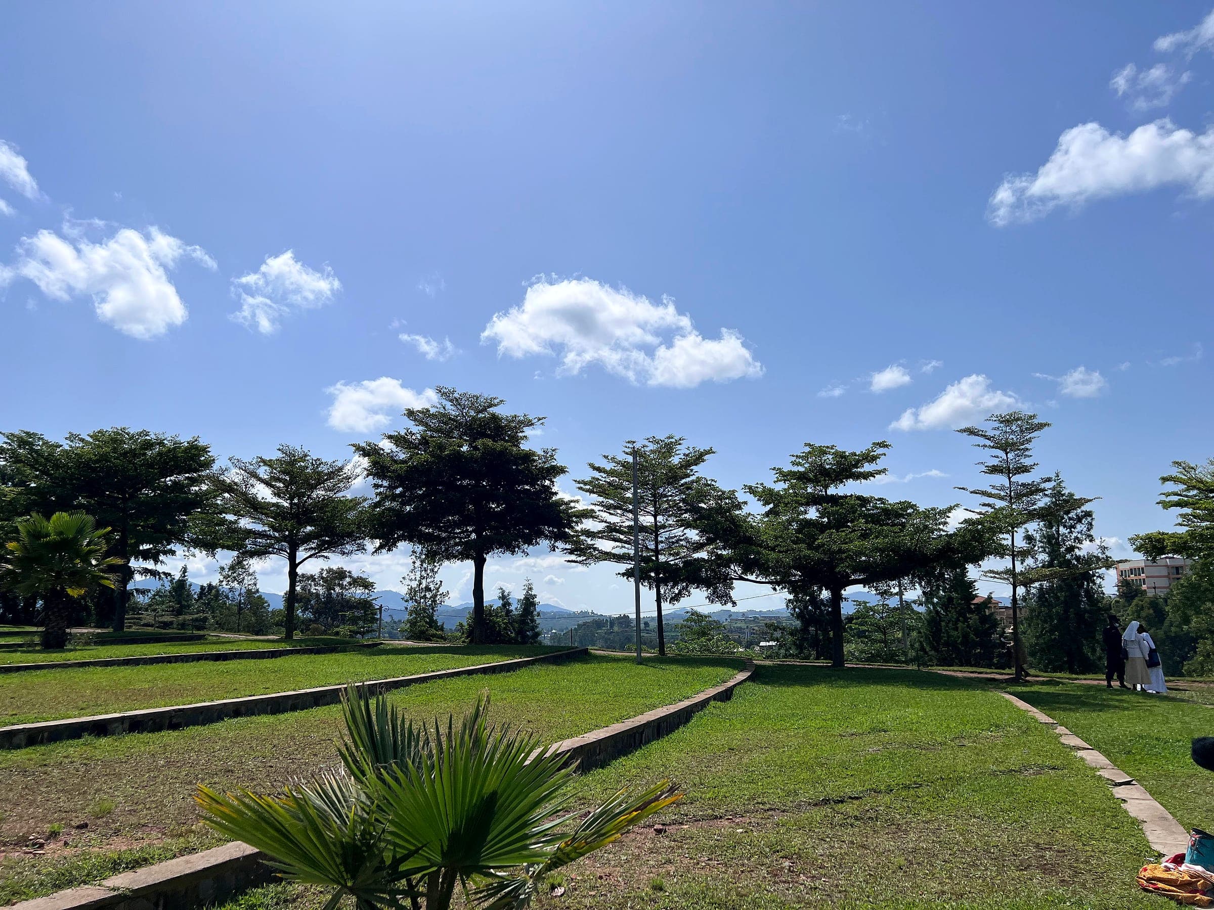 Pilgrims walking across the lawns of the Kibeho shrine